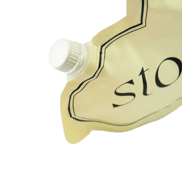 Clear squeeze pouch with handle for liquid packaging pouring scene